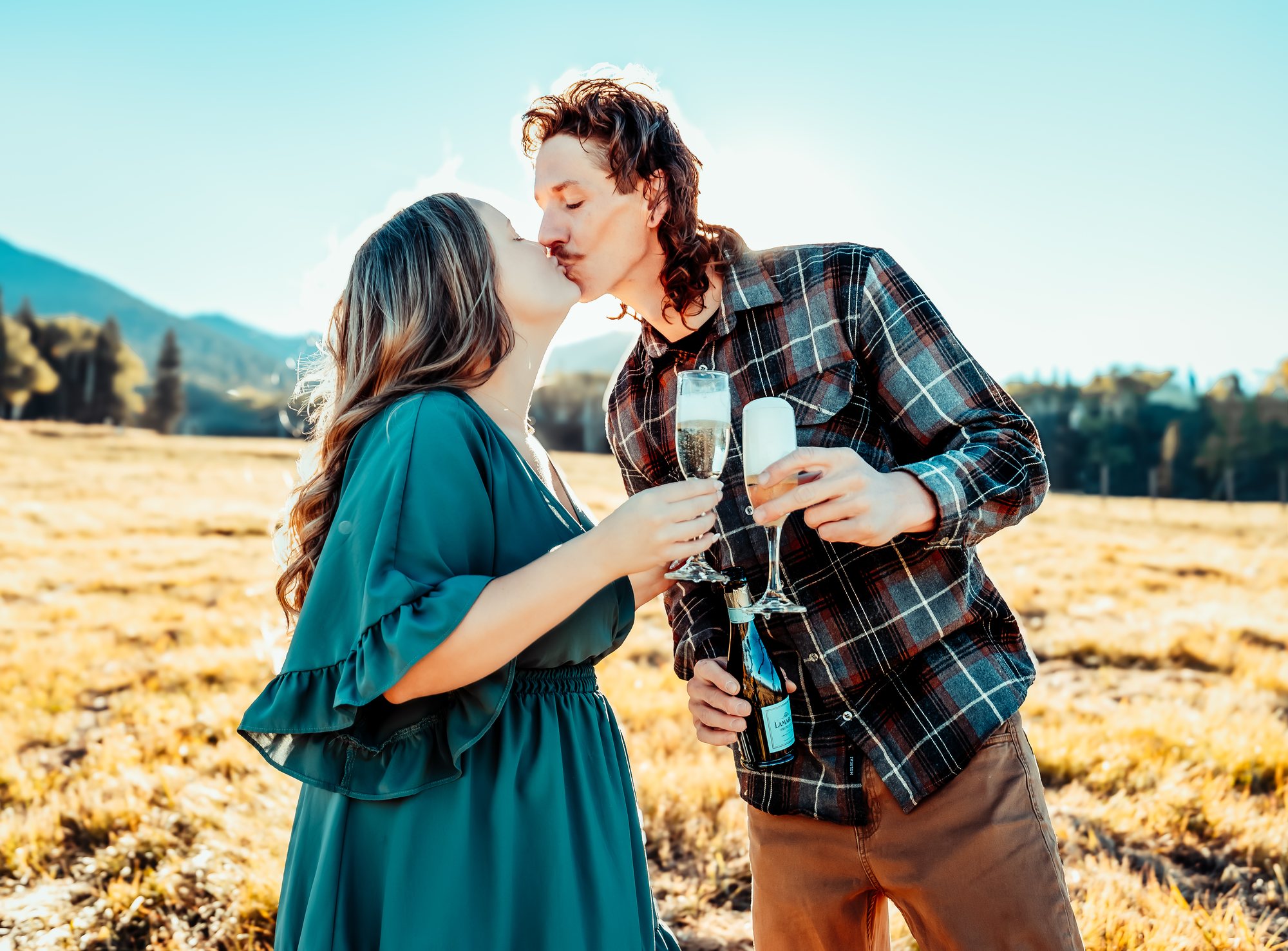 Courtney and Ken sharing a champagne kiss