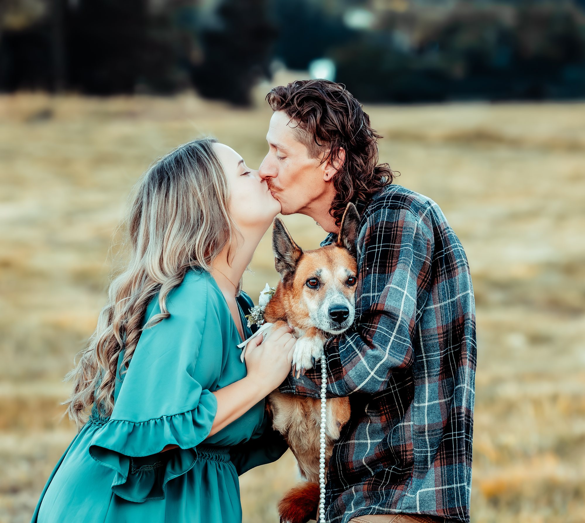 Courtney and Ken kissing with Bean between them
